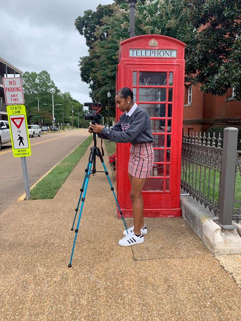 Tia Jackson using a camera at the Oxford Square