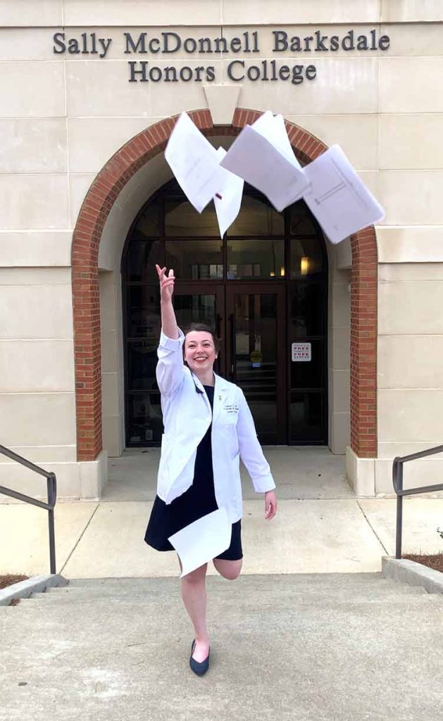 Kreusel celebrates in front of the Sally McDonnell Barksdale Honors College. Submitted photo 